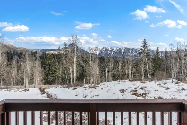 a view of a balcony with snow on the road
