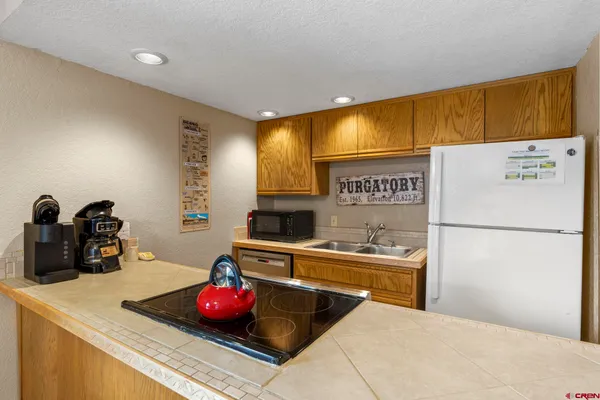 a kitchen with stainless steel appliances a sink and a refrigerator