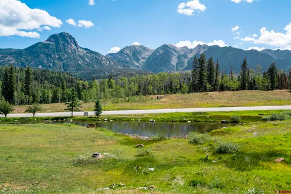 a view of a house next to a yard and mountain