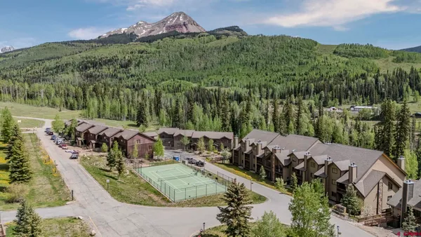 a view of a house with basketball court