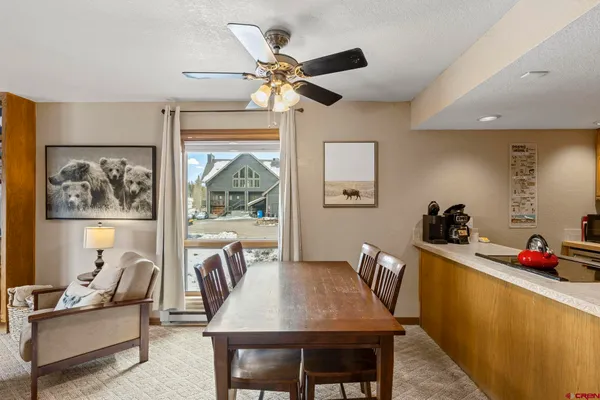 a dining room with furniture and window