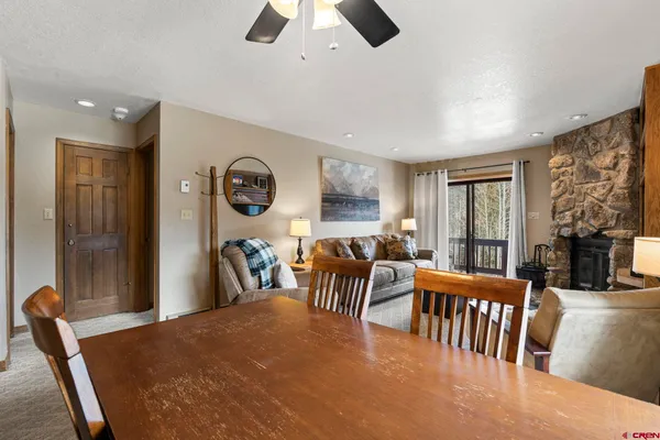 a dining room with furniture window and outside view