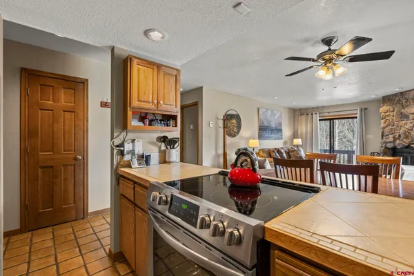 a kitchen with a stove a refrigerator and a dining table