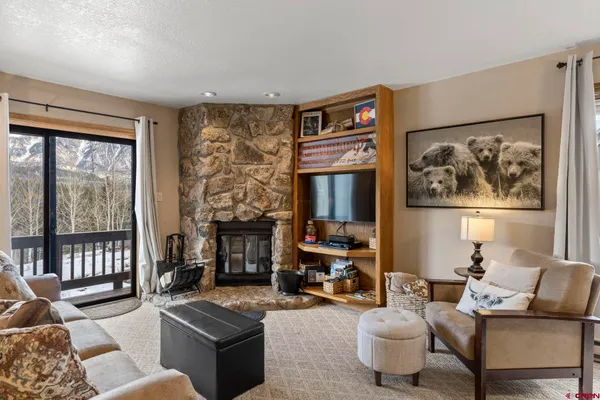 a living room with fireplace furniture and a window