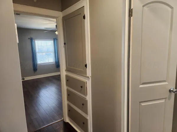 a view of closet area with wooden floor