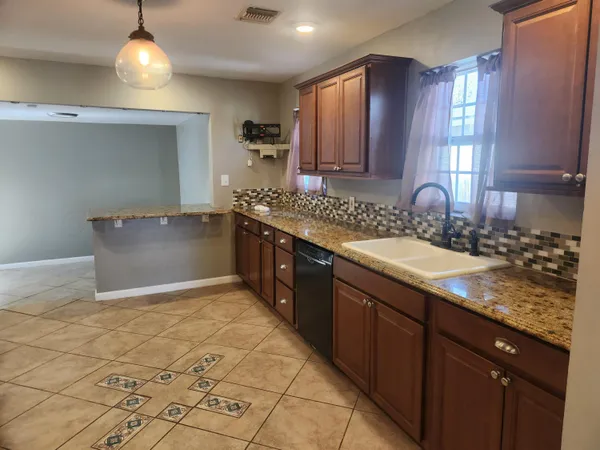 a kitchen with stainless steel appliances granite countertop a sink and a stove