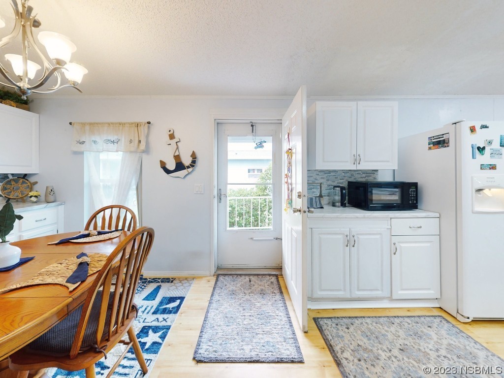 613 Portside Lane Edgewater, FL 32141 - Photo 11 of 49 a kitchen with stainless steel appliances granite countertop a refrigerator and a stove top oven