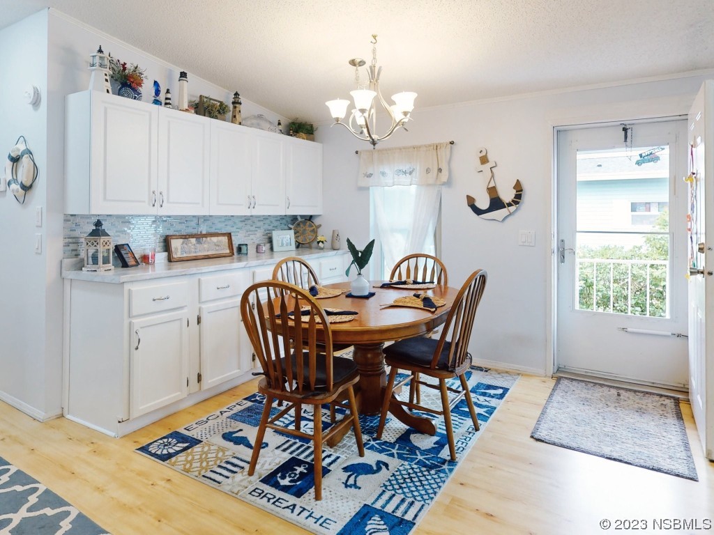 613 Portside Lane Edgewater, FL 32141 - Photo 12 of 49 a view of a dining room with furniture and chandelier