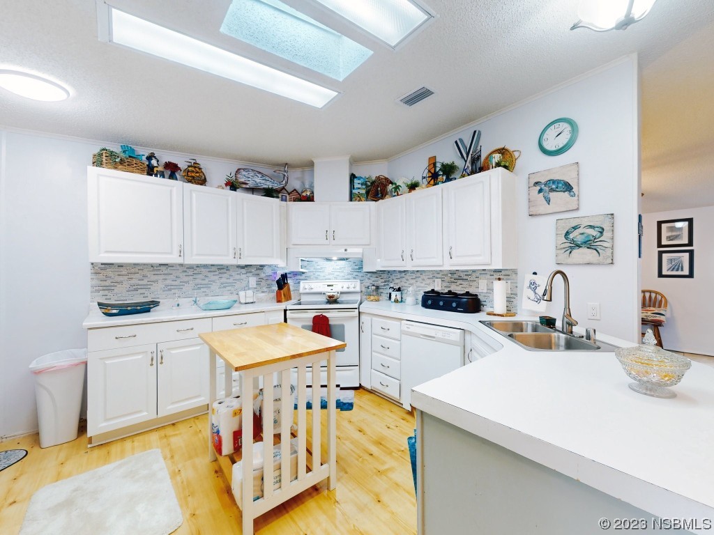 613 Portside Lane Edgewater, FL 32141 - Photo 15 of 49 a kitchen with a sink a stove and cabinets
