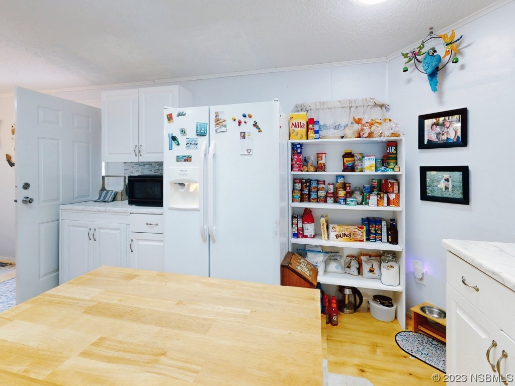 613 Portside Lane Edgewater, FL 32141 - Photo 16 of 49 a bed room with a bed and a television