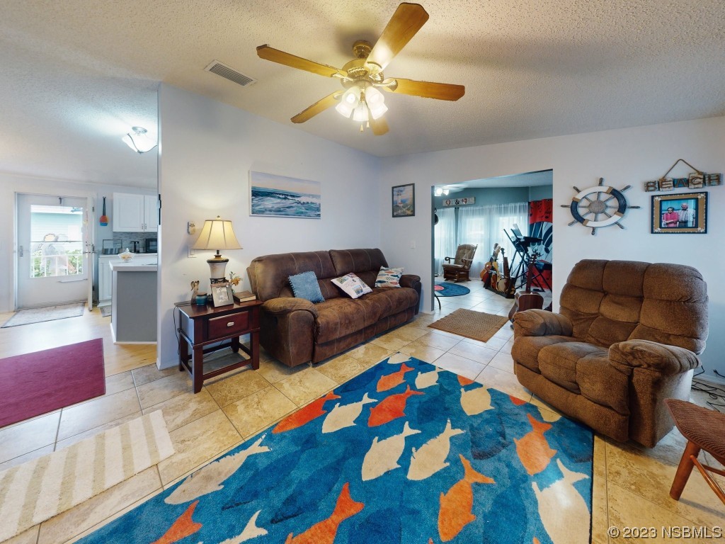 613 Portside Lane Edgewater, FL 32141 - Photo 19 of 49 a living room with furniture and wooden floor
