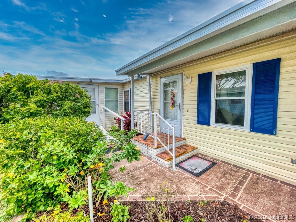 613 Portside Lane Edgewater, FL 32141 - Photo 2 of 49 a view of house with backyard and porch