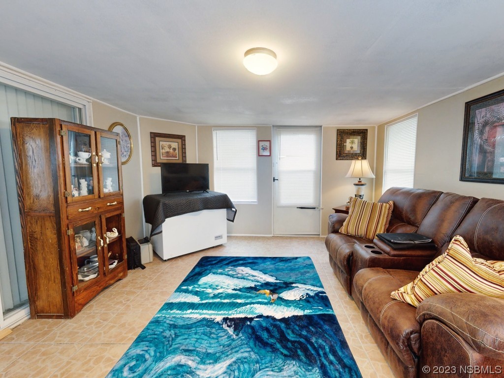 613 Portside Lane Edgewater, FL 32141 - Photo 22 of 49 a living room with furniture and a couch