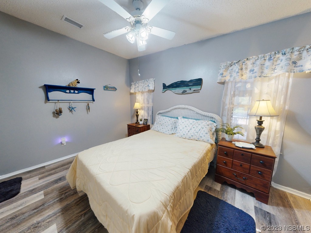 613 Portside Lane Edgewater, FL 32141 - Photo 23 of 49 a bedroom with a bed and a chandelier