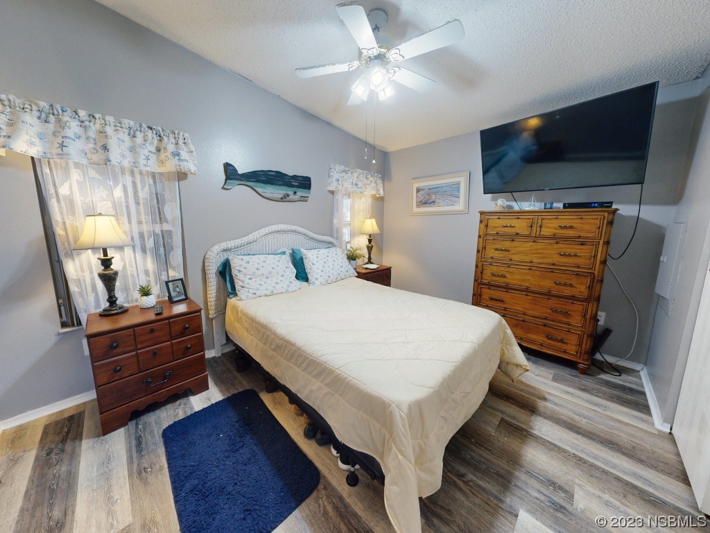 613 Portside Lane Edgewater, FL 32141 - Photo 27 of 49 a bedroom with a bed a flat screen tv and dresser