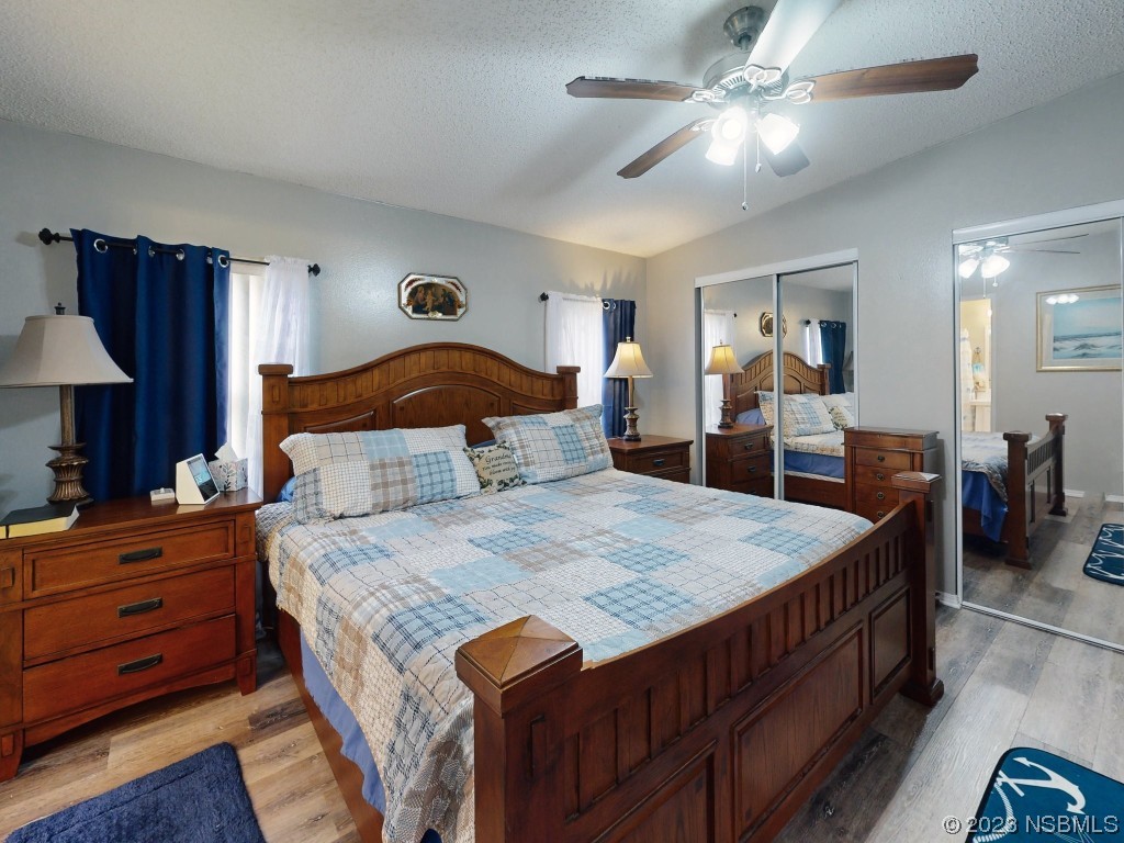 613 Portside Lane Edgewater, FL 32141 - Photo 28 of 49 a bedroom with a bed and a chandelier