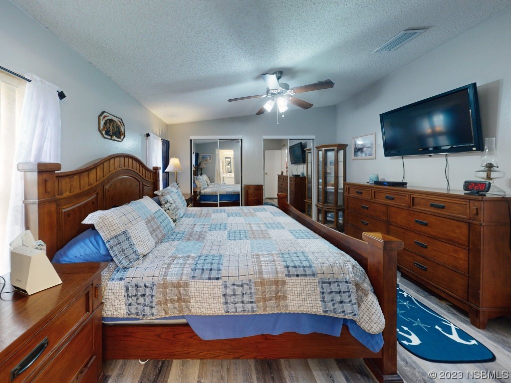 613 Portside Lane Edgewater, FL 32141 - Photo 29 of 49 a bedroom with a bed and a flat screen television