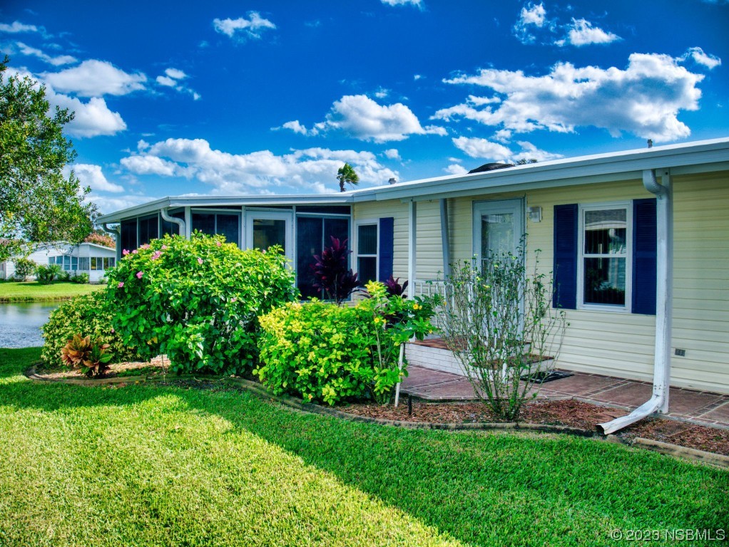 613 Portside Lane Edgewater, FL 32141 - Photo 3 of 49 a view of a house with a yard porch and sitting area
