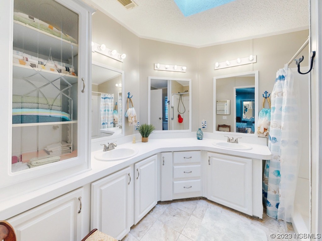 613 Portside Lane Edgewater, FL 32141 - Photo 31 of 49 a spacious bathroom with a sink and mirror