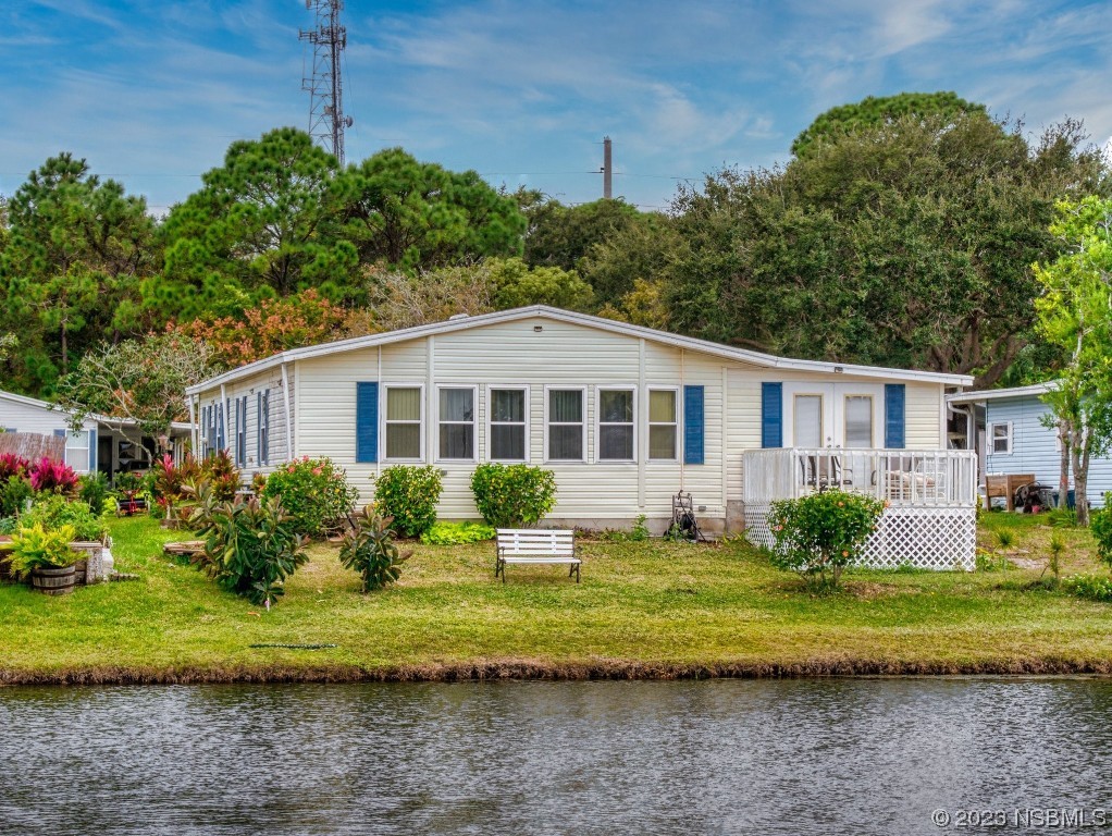 613 Portside Lane Edgewater, FL 32141 - Photo 4 of 49 a front view of a house with a yard