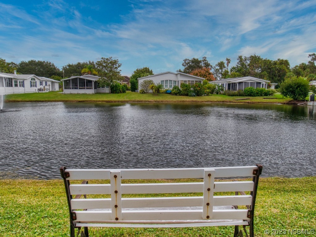 613 Portside Lane Edgewater, FL 32141 - Photo 5 of 49 a view of a lake with houses in the back