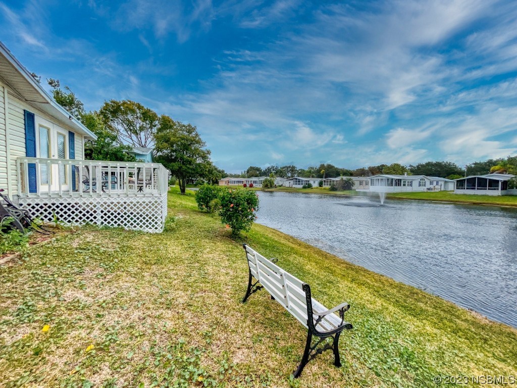 613 Portside Lane Edgewater, FL 32141 - Photo 6 of 49 a view of a swimming pool with an outdoor seating and a yard