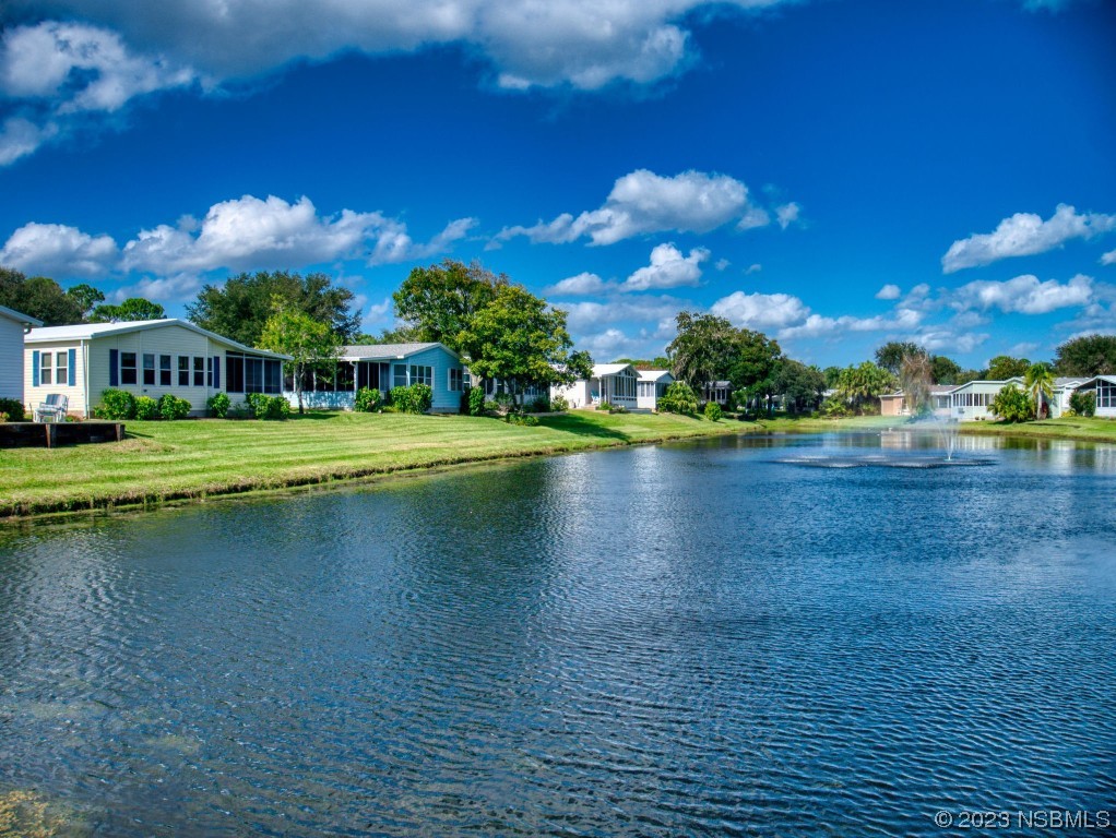 613 Portside Lane Edgewater, FL 32141 - Photo 7 of 49 a view of a lake with houses