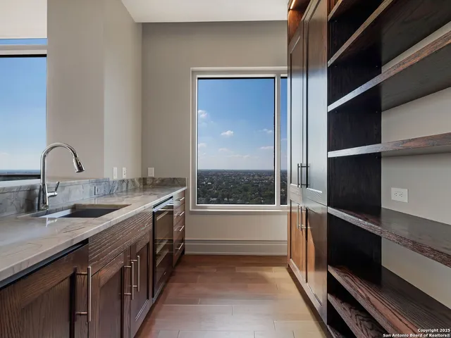 a kitchen with granite countertop a sink and a refrigerator