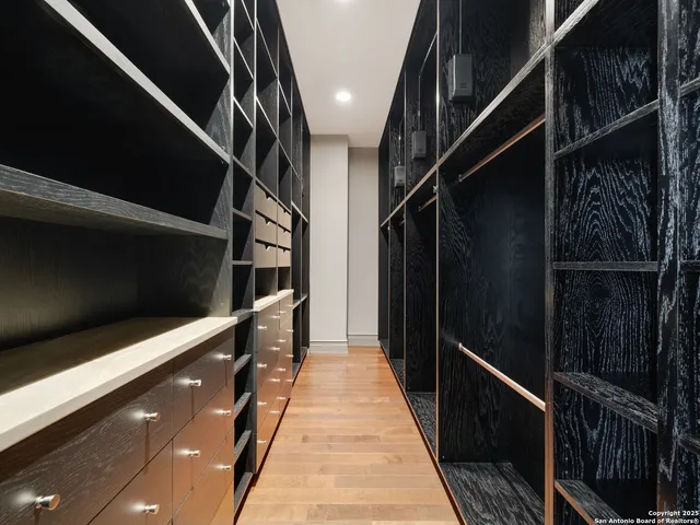 a view of walk in closet with empty racks
