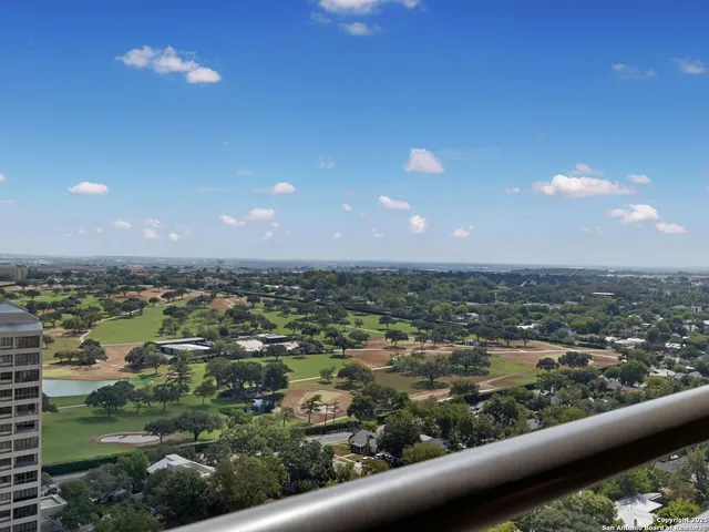 a bathroom with a granite countertop sink and a toilet