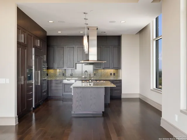 a kitchen with a sink cabinets and wooden floor