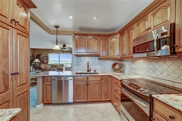 a kitchen with stainless steel appliances granite countertop a stove and a sink
