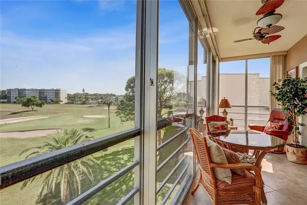 a view of a balcony with chairs and a table