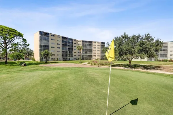 a view of an apartment building with a swimming pool