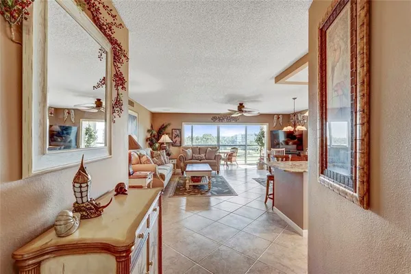 a very nice looking living room with a large window and furniture
