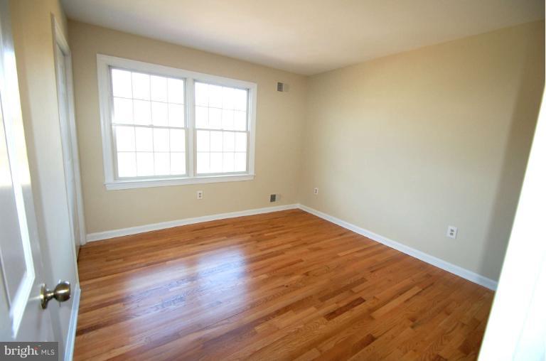 1904 Ednor Road Silver Spring, MD 20905 - Photo 18 of 30 an empty room with wooden floor and windows