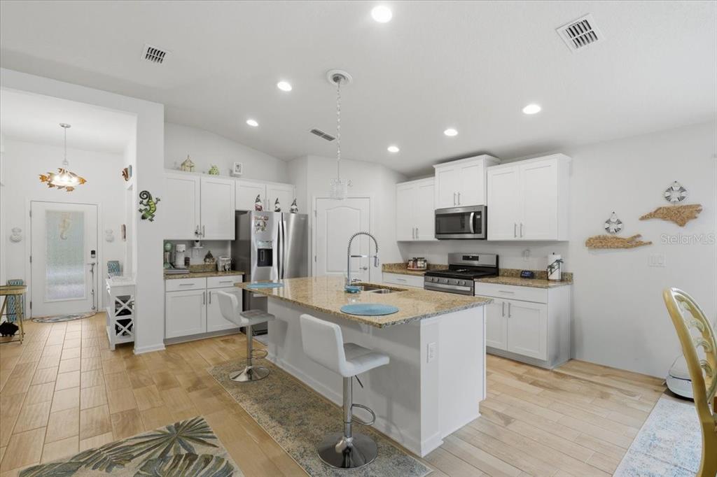 35 Birdie Way Bunnell, FL 32110 - Photo 7 of 57 a kitchen with white cabinets and stainless steel appliances
