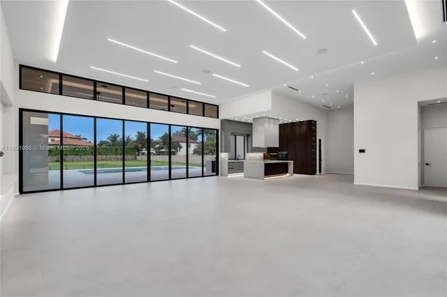 a kitchen with stainless steel appliances kitchen island granite countertop a dining table and chairs