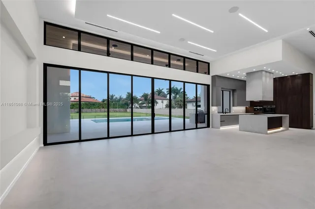 a large kitchen with stainless steel appliances granite countertop a large counter top and a stove