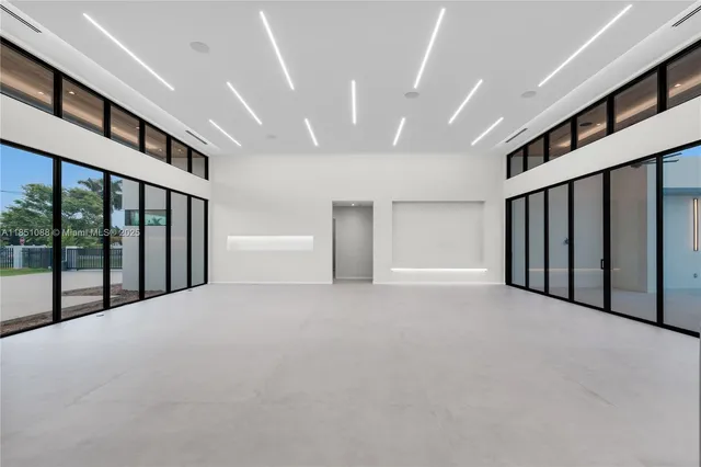 a large white kitchen with a large counter top appliances and cabinets