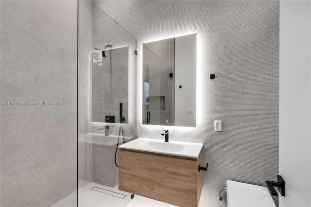 a view of an empty room with closet and a window