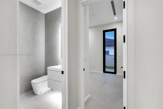 wooden floor with pool table and windows