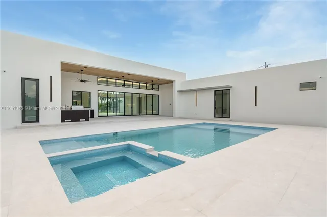 a view of a house with a big yard and large trees