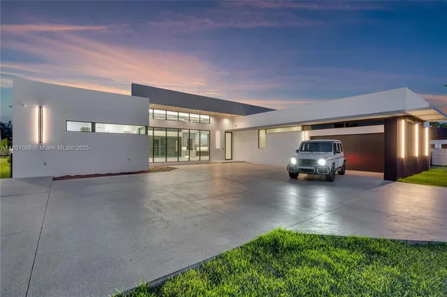 a view of a big room with a big yard potted plants and large tree