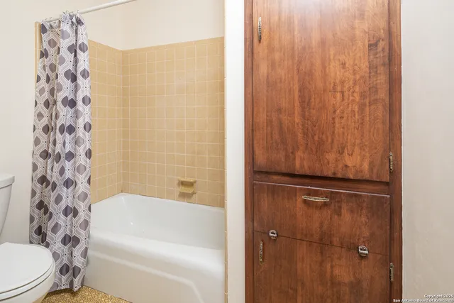 a bathroom with a bathtub and shower