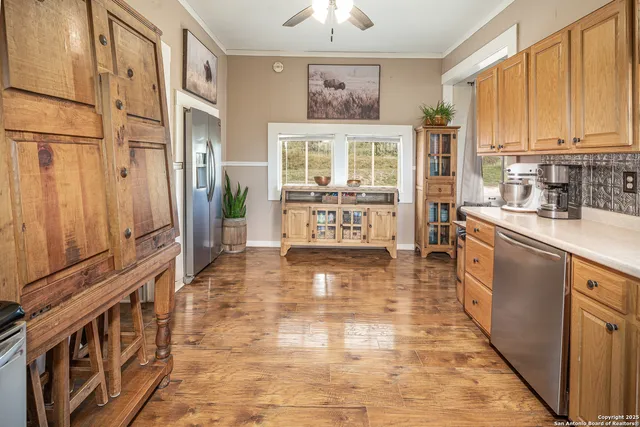 a kitchen with stainless steel appliances granite countertop a stove a sink and a refrigerator