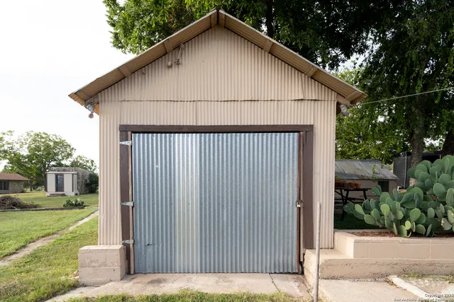 a view of backyard with outdoor seating and green space