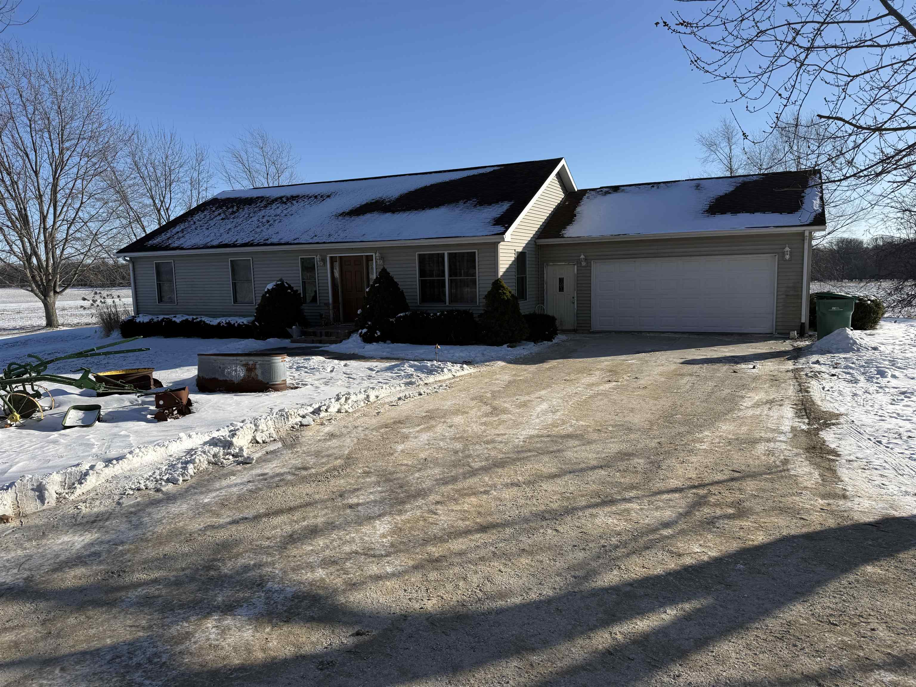 a front view of house with yard covered in snow