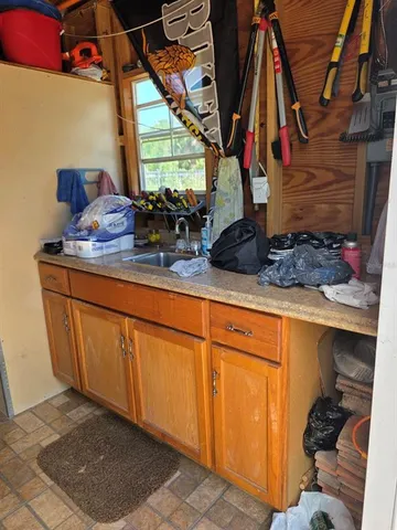 a kitchen with stainless steel appliances granite countertop a refrigerator and a wooden floor