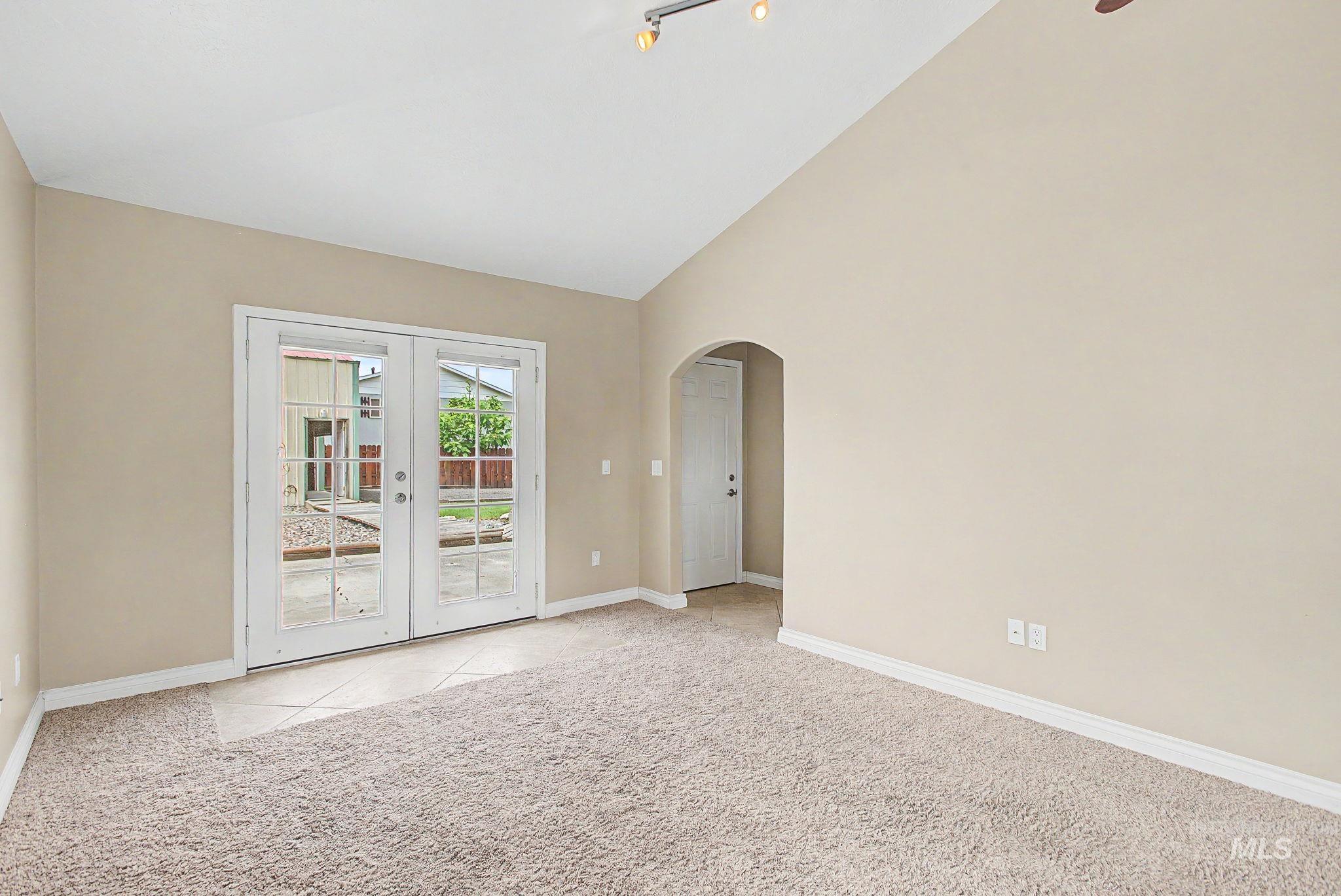 3314 6th Street Lewiston, ID 83501 - Photo 17 of 50 Vaulted ceiling room featuring beige carpeting, white baseboards, and neutral wall tones